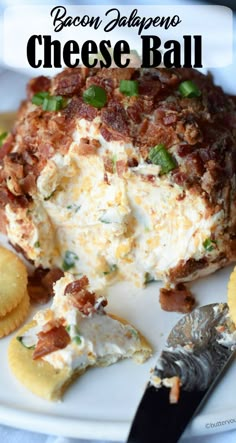 bacon jalapeno cheese ball on a white plate with crackers next to it