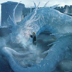 a woman standing next to a giant dragon