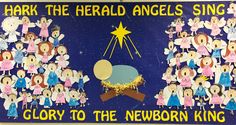 a nativity scene with angels, stars and the birth of jesus is displayed on a bulletin board