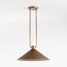 a brass pendant light hanging from the ceiling