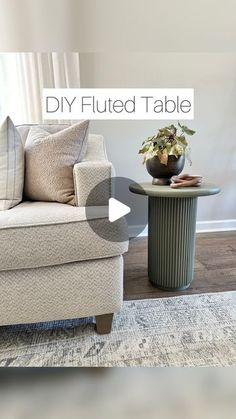 a living room with a couch, table and rug on the floor in front of it