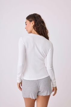 This item is Final Sale. Make it the comfiest season yet with our ivory long sleeve henley top. The neutral hue and delicate knit make it an essential piece for layering or wearing solo for a cozy, understated look. White Henley For Fall, Winter White Long Sleeve Loungewear Top, Winter White Long Sleeve Lounge Top, White Crew Neck Henley For Everyday, White Henley Top For Fall, White Henley Neckline Top For Fall, Everyday Ribbed Henley Neckline Tops, Everyday Ribbed Henley Tops, Winter White Ribbed Crew Neck Top