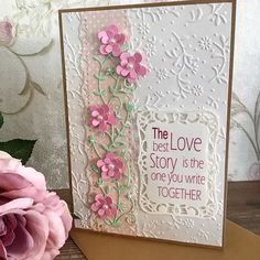 a card with pink flowers and the words, the best love story is the one you write together