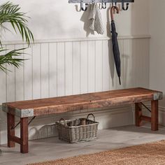 a wooden bench sitting next to a potted plant