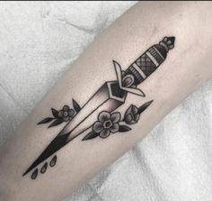 a black and white photo of a tattoo with a rocket ship on it's arm