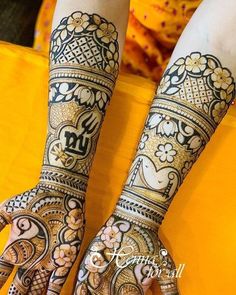 two hands with henna designs on them