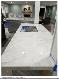 a kitchen counter is being installed in the middle of a room with an open floor plan