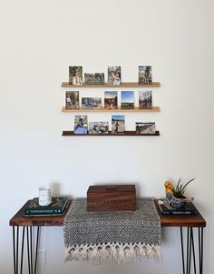 two tables with pictures on the wall above them and a table runner underneath one that has hairpin legs