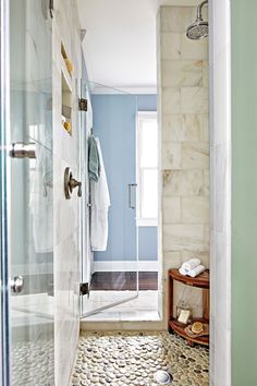 a bathroom with blue walls and marble flooring