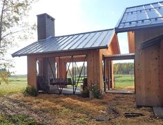 a small wooden house with a metal roof