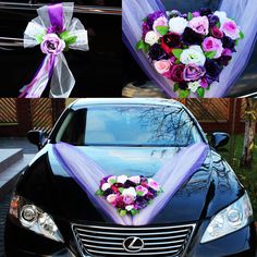 purple and white flowers are tied to the hood of a black car with ribbons on it