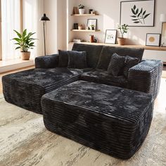 a large black couch sitting on top of a wooden floor