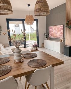 a living room filled with furniture and a flat screen tv on top of a wooden table