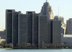 an airplane flying over a large city with tall buildings in the backgrouds