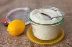 there is a spoon in a jar next to a lemon