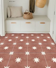 a white bench sitting next to a window on top of a tiled floor covered in stars