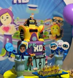 the cake is decorated with cartoon characters and balloons