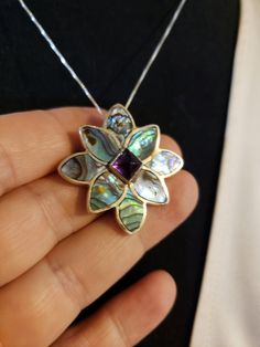 "Super HIGH QUALITY Everything! All Sterling Silver in a flower shape; Petals are all made of inlaid ABALONE (specifically from New Zealand and called Paua Shell - very intense colors); Center is a 7x7mm Sugarloaf cut AMETHYST. **THIS PIECE IS BOTH A PENDANT AND A PIN OR BROOCH** Measures 1.25\" each direction. I am including an 18\" Sterling Silver chain too. Hallmarked SAJEN 925 By the renowned designers RICHARD & MARIANNA JACOBS, the OFFERINGS line by SAJEN. Made in Bali. Contact me with Amethyst Flower-shaped Jewelry Gift, Purple Flower-shaped Nickel-free Jewelry, Flower Shaped Amethyst Jewelry For Gift, Purple Nickel-free Flower-shaped Jewelry, Amethyst Flower Jewelry Gift, Amethyst Flower Jewelry For Gifts, Purple Nickel-free Flower Jewelry, Purple Sterling Silver Flower-shaped Jewelry, Amethyst Flower Pendant Jewelry Gift