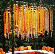 an orange and white wedding with lots of flowers on the wall behind the couches