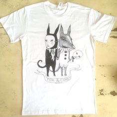 A t-shirt for Creatures, by Creatures.  Screen-printed. Black ink on white or green cotton. Sizing: size are unisex. The t shirts are made by Ascolour.  100% cotton.  Machine wash cold. Cotton T-shirt With Custom Artwork In Relaxed Fit, Cotton T-shirt With Custom Artwork And Relaxed Fit, White Crew Neck T-shirt With Hand Printed Details, White Hand-printed Crew Neck T-shirt, White Cotton Shirt With Custom Artwork, Hand Printed White T-shirt For Summer, White Hand Printed T-shirt For Summer, White Hand-printed T-shirt For Summer, Summer Unisex Hand Printed T-shirt