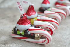 candy canes with santa hats on them are lined up