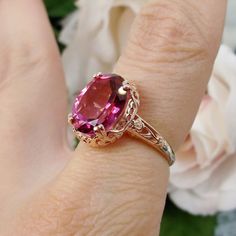 Inspired by Edwardian jewelry of the early 1900s, I now offer this lovely Antique reproduction ring in sterling silver rose gold plated. This gorgeous ring is set with a stunning Natural Pink Topaz gemstone. This genuine brilliant pink topaz has excellent color and clarity. The oval cut 3.41ct Topaz is 12mm (9/16th of an inch) Long by 10mm Wide (3/8th"). The ring sits 6mm off the finger. The inside of the band s marked 925 for sterling. Formal Rose Gold Topaz Ring With Accent Stones, Elegant Pink Ruby Gemstones, Elegant Pink Topaz Ring For Anniversary, Elegant Pink Topaz Anniversary Ring, Formal Pink Gold Jewelry With Accent Stones, Formal Rose Gold Topaz Ring With Prong Setting, Heirloom Rose Gold Topaz Gemstone Ring, Classic Wedding Gemstones With Accent Stones, Classic Pink Gemstones For Formal Occasions