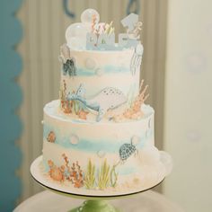 a three tiered cake decorated with sea animals