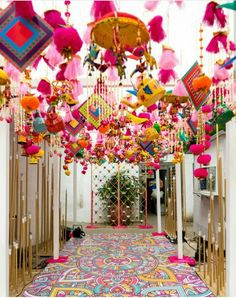 an elaborately decorated hallway with lots of colorful decorations hanging from it's ceiling