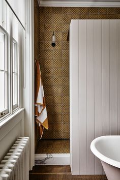 a white bath tub sitting next to a window