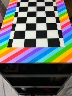 a multicolored checkerboard table with black and white squares on it's surface