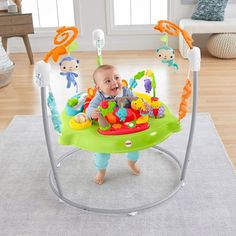 a baby is sitting in a bright green and gray jumper with toys on it's back