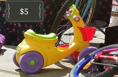 two children's tricycles sitting next to each other on the sidewalk with a price tag for $ 5