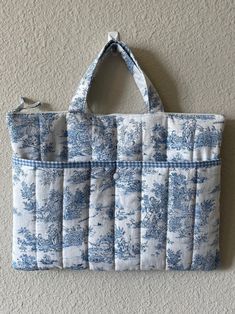 a blue and white bag hanging on the wall