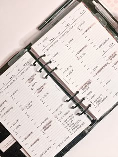 an open planner book sitting on top of a desk