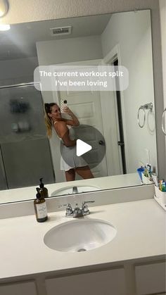 a woman taking a selfie in front of a bathroom mirror with the caption, this current workout split i've been loving