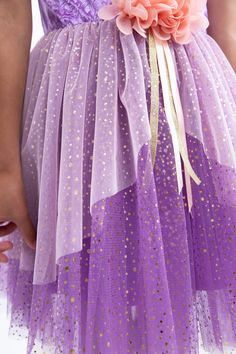 Your little one will be instantly transported into a magical world of princes, witches, and castles with our Rapunzel Party dress. Purple stretch velvet bodice "laced" up with sparkling gold trim Puffy purple velvet sleeves with pink ribbon accents Tea-length skirt with light pink organza overlay, embellished with pale pink flowers at the waist Breathable, Silky Soft, 100% Polyester Fabrics Accessories Sold Separately Purple Fairy Dress For Dress-up Occasions, Purple Fairy Style Dress For Dress-up, Purple Fairy Costume Dress, Purple Fairytale Dress For Fancy Dress Occasion, Fairytale Purple Dress For Party, Purple Fairytale Fancy Dress, Purple Tulle Dress For Costume Party, Purple Princess Tutu Dress For Dress-up, Purple Princess Fairy Dress For Costume Party