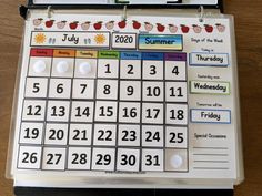 a calendar is hanging on a clipboard with magnets attached to the front and sides