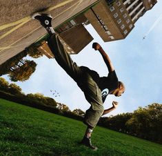 a skateboarder is doing a trick in the air with his board behind him