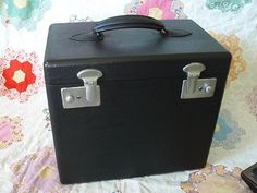 a black suitcase sitting on top of a bed