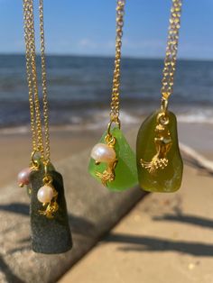 Beautiful, one of a kind sea glass mermaid pendant necklaces. Every piece of glass is different and unique, so no two necklaces are the same. The pictures in the listing are examples of what you can expect to receive when you purchase a necklace. Available on silver or gold chains, with matching mermaid and pearl charms. All the different shades of green sea glass  come to life when they are worn in the sun light. Perfect for any beach babe or coastal cowgirl. ️🫶 *All glass is personally sourced by me from the shores of the Chesapeake Bay. No two pieces are alike! Pictures here are examples only and are not necessarily the exact pieces you will receive! Enjoy your one of a kind piece!* Handmade Ocean-inspired Sea Glass Necklaces, Ocean-inspired Charms Necklaces For Gifts, Ocean-inspired Charms Necklace As Gift, Ocean-inspired Charms Necklace For Gift, Ocean-inspired Recycled Glass Jewelry As Gift, Unique Handmade Sea Glass Necklaces, Handmade Unique Necklace With Sea Glass, Ocean-inspired Glass Necklaces For Gifts, Gold Necklace With Recycled Glass For Gifting