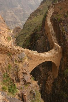 a bridge that is on the side of a mountain