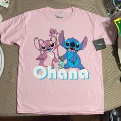 This Adorable Tee Shirt Features Experiment 626 And Experiment 624 Aka Stitch And Angel From Disney’s Lilo And Stitch Along With Scrump Underneath It Says Ohana Check Out My Other Lilo And Stitch Stuff To Bundle! Any Questions Please Ask! Casual Pink Cartoon Print Tops, Pink Cute Shirt With Character Print, Cute Pink Shirt With Character Print, Pink Cartoon Print Tops With Relaxed Fit, Pink Cartoon Print Top With Relaxed Fit, Pink Cartoon Print Top In Relaxed Fit, Pink Relaxed Fit Tops With Cartoon Print, Fun Pink Shirt With Cartoon Print, Playful Pink Shirt With Letter Print