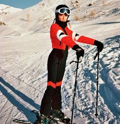 a woman on skis standing in the snow