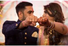 a bride and groom holding their hands together