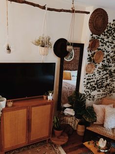 a flat screen tv sitting on top of a wooden cabinet