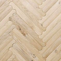 an image of wood flooring that looks like herringbones or chevrons