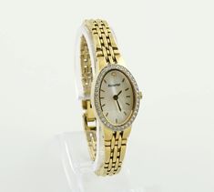 This delicate and elegant gold-colored watch boasts an oval case surrounded by set stones, paired with a mother-of-pearl dial for a touch of sophistication. It features a classic metallic bracelet, blending timeless elegance with modern design. The watch represents a perfect marriage of traditional aesthetics and contemporary craftsmanship, making it a versatile accessory for any occasion. Dimensions: Bracelet Length: up to 15.3 cm (6 inches) - adjustable Case Width: 1.7 cm (0.7 inches) Bracelet Metallic Bracelet, A Perfect Marriage, Watch Women's, Watch Gift, Perfect Marriage, Women Wrist Watch, Metal Bracelets, Wrist Watches, Quartz Watch