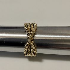 a close up of a metal object with beads on it's end and in the middle