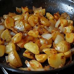 cooked potatoes and onions in a frying pan