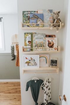 a baby's room with books and toys on the shelves